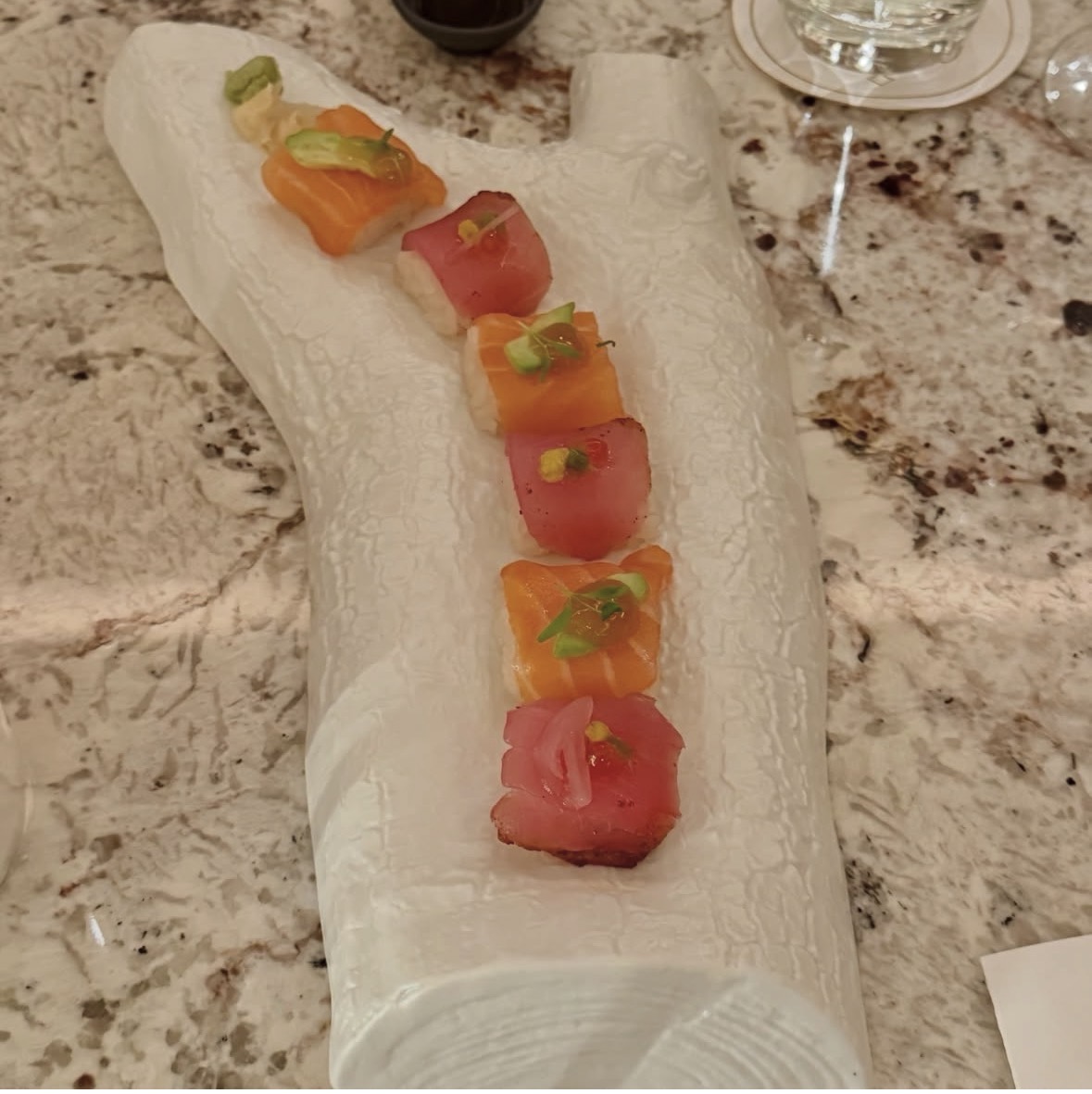 Omakase nigiri selection served on ceramic bark