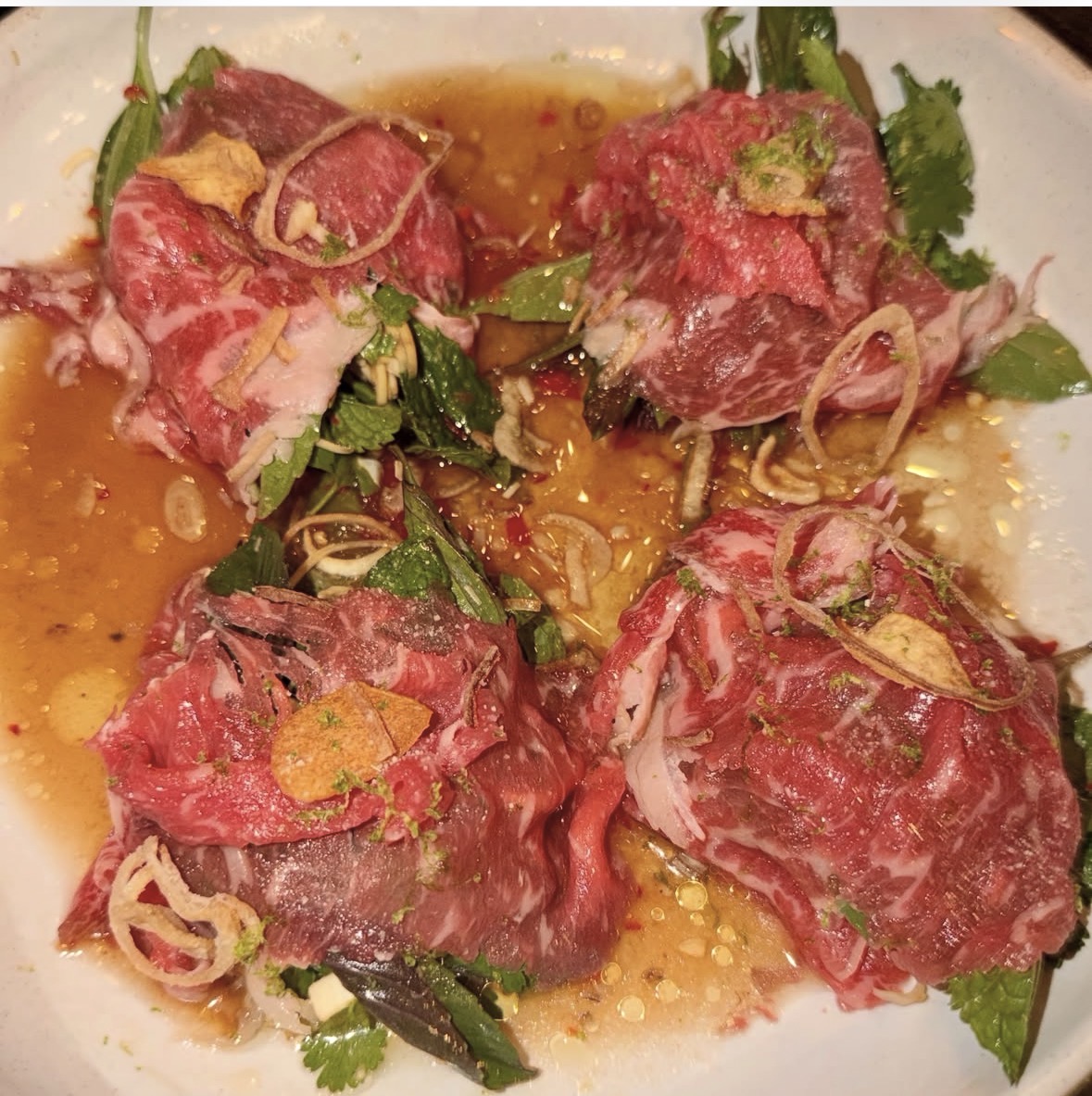 Wagyu carpaccio with herbs and crispy shallots