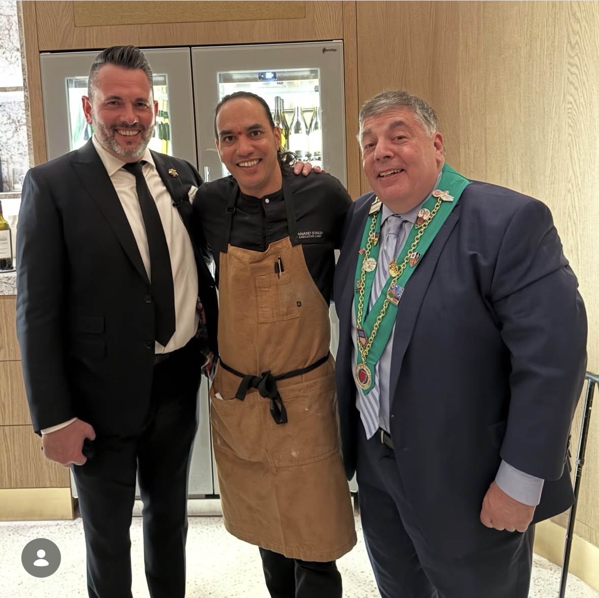 Members with Chef Anand Singh in the kitchen